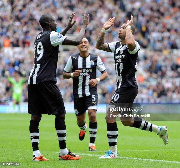 Leon Best of Newcastle United celebrates scoring his side's second goal with team-mate Demba Ba during the Barclays Premier League match between...