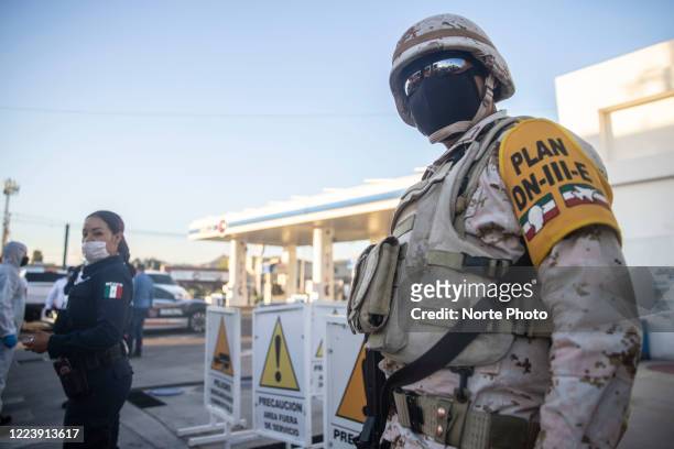 Soldiers of the Mexican army support local police in an operation to measure the temperature to drivers on May 9 29, 2020 in Hermosillo, Mexico....
