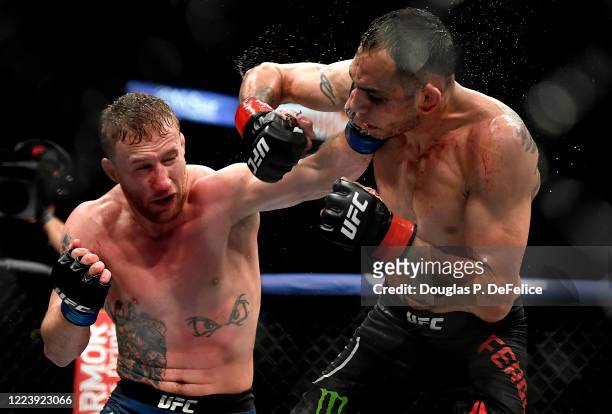 Justin Gaethje of the United States punches Tony Ferguson of the United States in their Interim lightweight title fight during UFC 249 at VyStar...