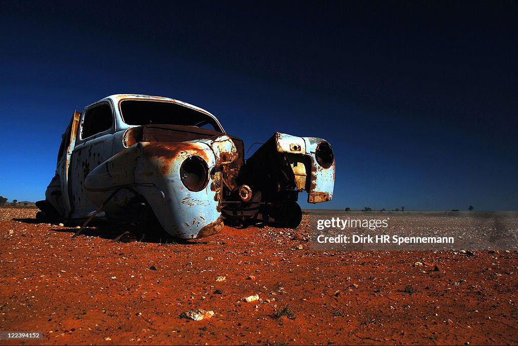 Car wreck in stony desert