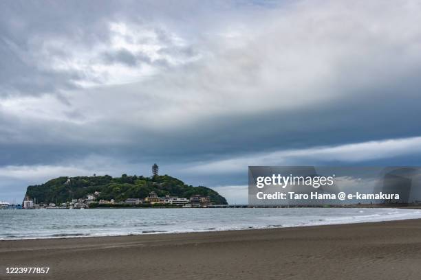 storm clouds on the beach in kanagawa prefecture of japan - enoshima island stock pictures, royalty-free photos & images