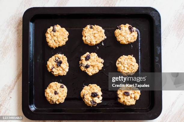 still life of home made raw oatmeal cookies ready for baking - raisin stock-fotos und bilder