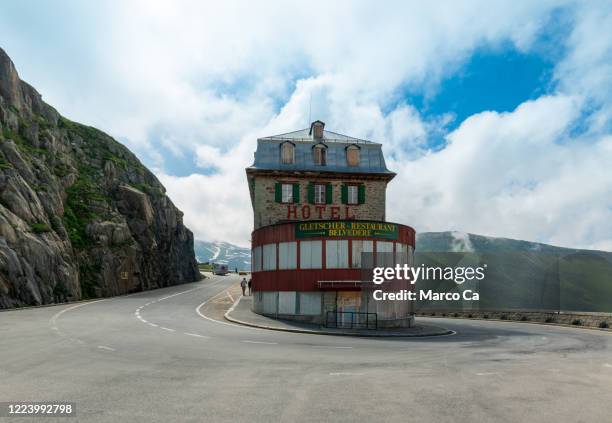 front view of the famous hotel and restaurant belvédère with sharp hairpin and city sign at the furka pass street - belvedere hotel stock pictures, royalty-free photos & images