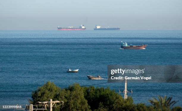 fishing and cargo container ships sailing in the strait of hormuz by qeshm island, persian gulf, iran - stretto foto e immagini stock