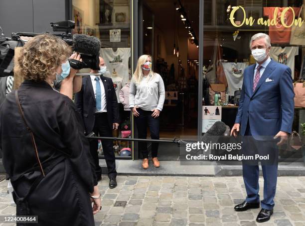 May 10: A day before the official reopening, King Philippe of Belgium visits newly reopened family stores which were required to remain closed during...