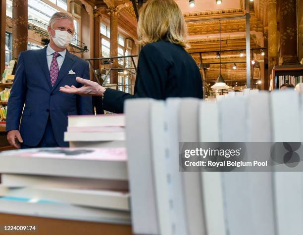 May 10: A day before the official reopening, King Philippe of Belgium visits newly reopened family stores which were required to remain closed during...