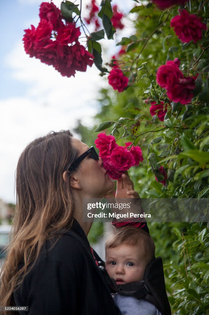 Mother Holding Toddler Smell Roses