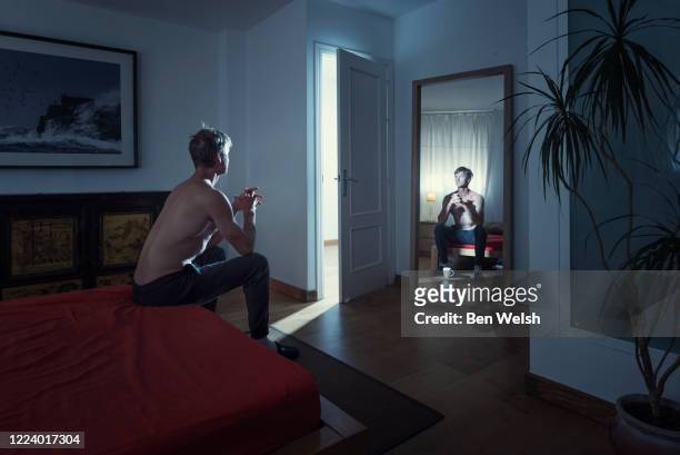 man alone in his bedroom - mirror reflection stock pictures, royalty-free photos & images