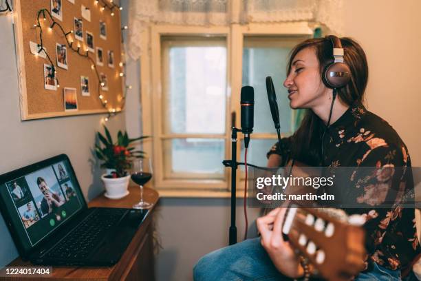 teleconferencing with music - martin guitar stock pictures, royalty-free photos & images