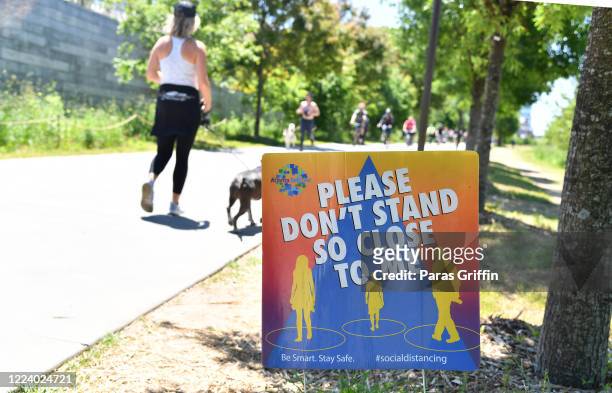 Sign displays "Please Don't Stand So Close To Me" at the Atlanta Beltline as the coronavirus pandemic continues on May 10, 2020 in Atlanta, Georgia....