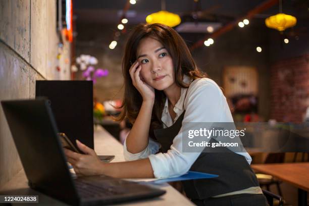 coffee shop owner worry about her business - bankruptcy stock pictures, royalty-free photos & images
