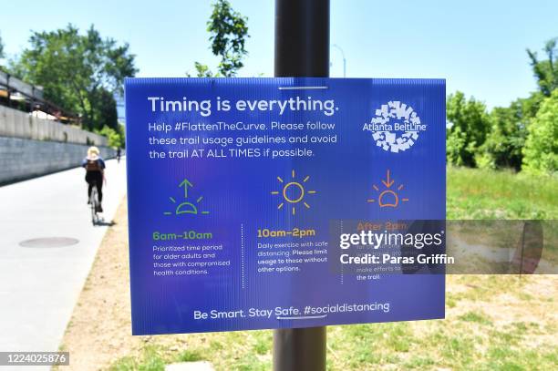 Sign displays "Timing is everything. Help Flatten The Curve." at the Atlanta Beltline as the coronavirus pandemic continues on May 10, 2020 in...