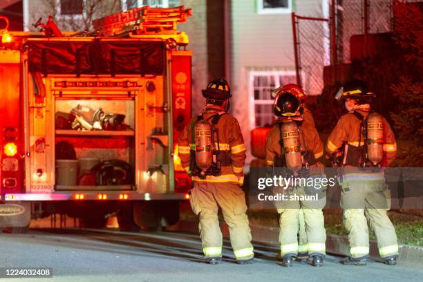 firefighters respond to house fire - emergency response stock pictures, royalty-free photos & images
