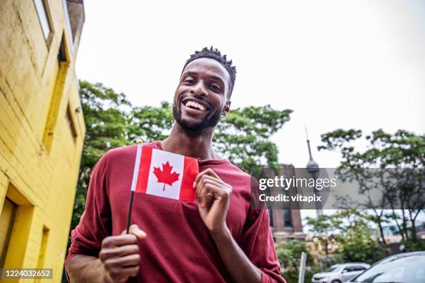 happy canadian man - canada day celebration stock-fotos und bilder