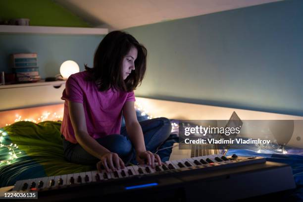 a young gril practicing a song on a piano - girl singing stock pictures, royalty-free photos & images