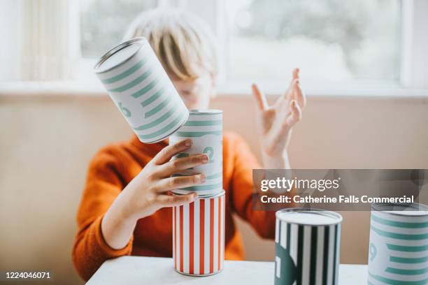 boy stacking cans - man made stock pictures, royalty-free photos & images