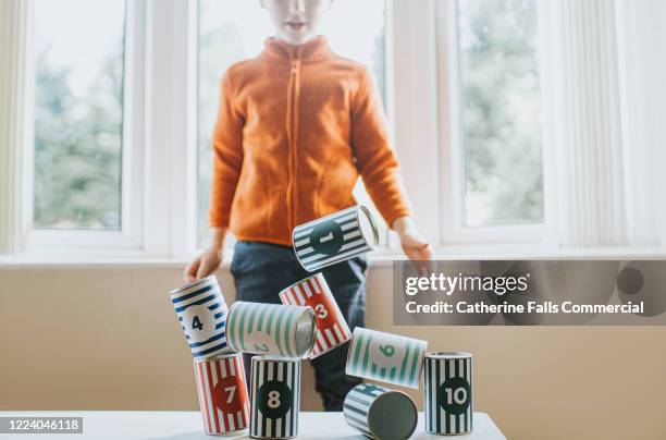 tin can topple game - falling house of cards stock pictures, royalty-free photos & images