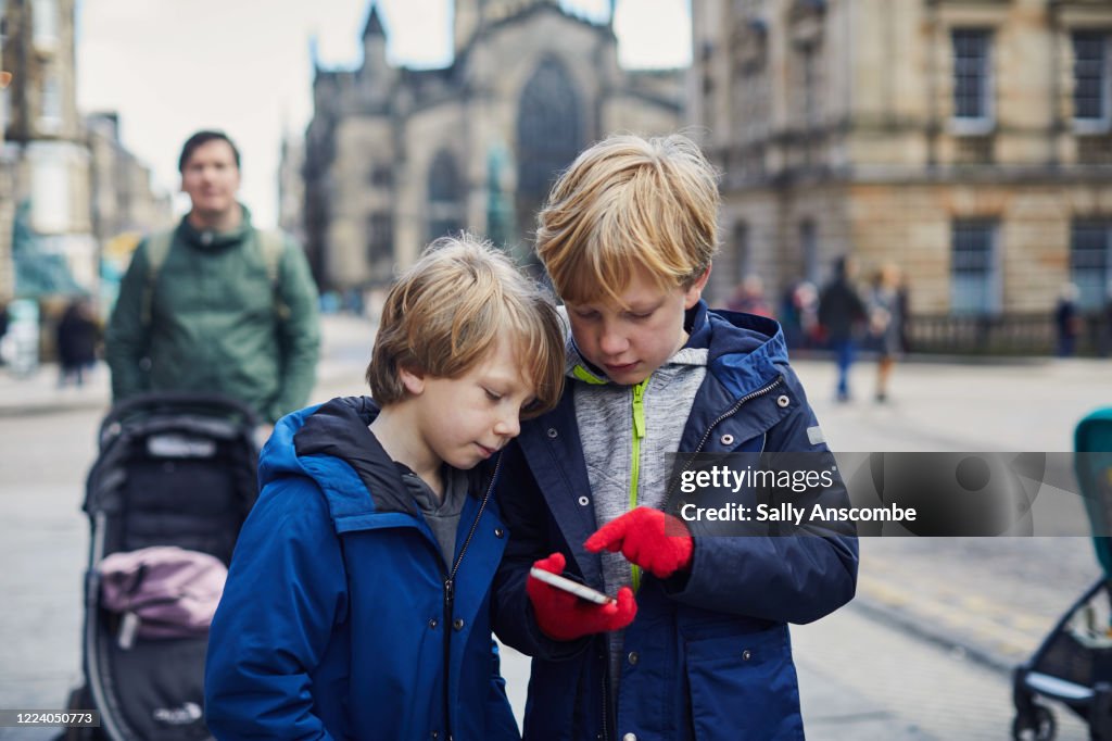 Children looking at a smart phone together