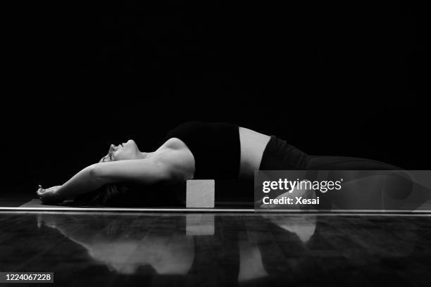 yoga on black background - monochrome 700063863 stock pictures, royalty-free photos & images