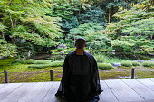 Buddhist monks performing zen in the fresh green