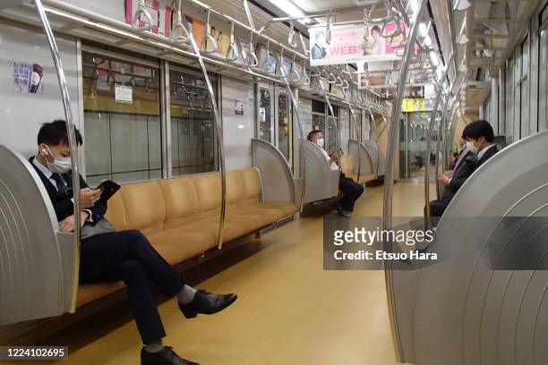 Few people wearing face masks are seen at Yurakucho line train amid the coronavirus pandemic on May 11, 2020 in Tokyo, Japan.