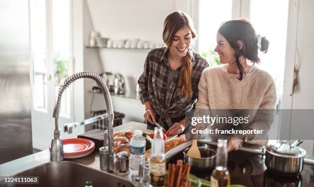 happiness friends cooking together at home - woman cooking stock pictures, royalty-free photos & images