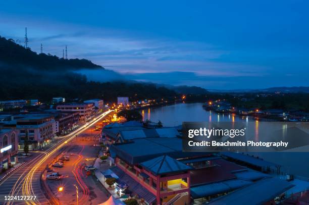 high angle scenic view of limbang town light trails and reflections at dusk, sarawak, malaysian borneo - kuching sarawak stock pictures, royalty-free photos & images