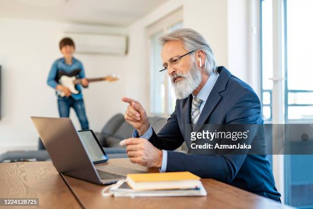 businessman and young son at home during 2020 quarantine - working from home funny stock pictures, royalty-free photos & images