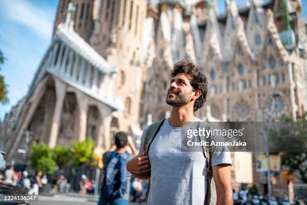 mid adult male tourist with smart phone in barcelona - sagrada família imagens e fotografias de stock
