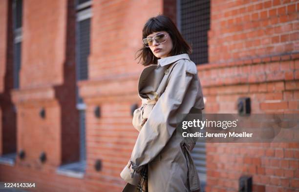 Lea Neumann wearing Burberry trenchcoat, Balenciaga Triple S and weekday pants and shirt on May 06, 2020 in Berlin, Germany.