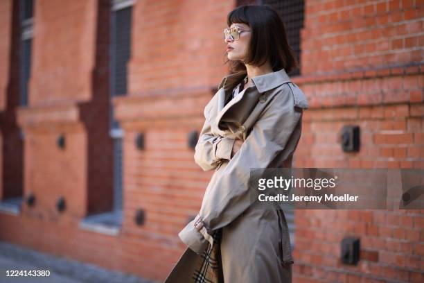 Lea Neumann wearing Burberry trenchcoat, Balenciaga Triple S and weekday pants and shirt on May 06, 2020 in Berlin, Germany.