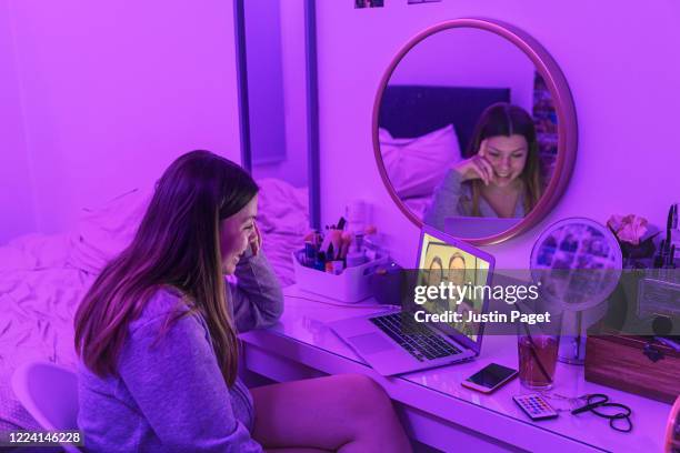 teenage girl on video call to her parents - purple room stock pictures, royalty-free photos & images