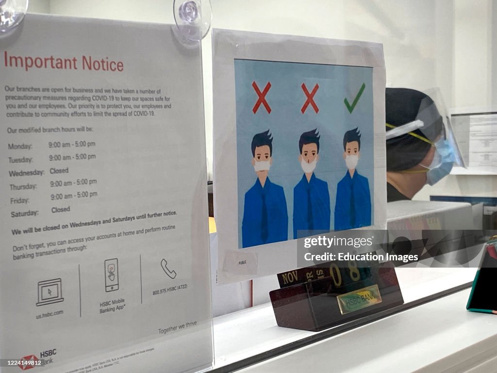 HSBC Bank, bank teller with safety warning signs, Forest Hills, Queens, NY