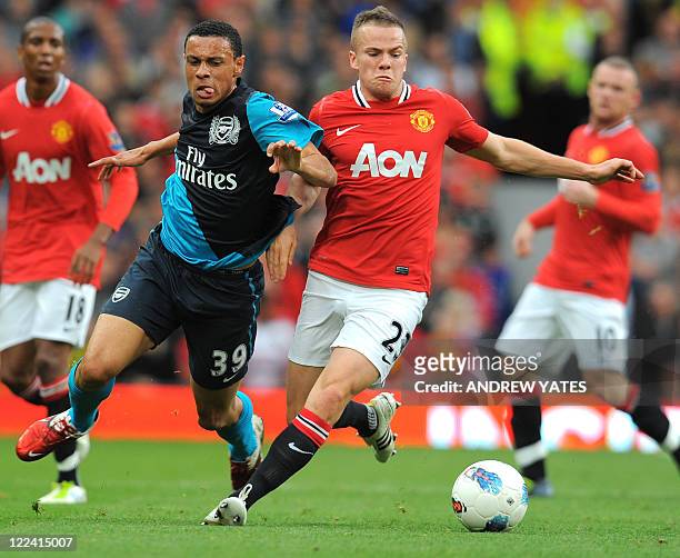 Arsenal's French midfielder Francis Coquelin vies with Manchester United's English midfielder Tom Cleverley during the English Premier League...