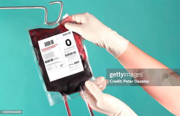 nurse hanging up blood bag - blood bag stock pictures, royalty-free photos & images