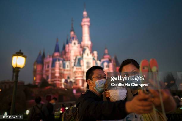 Tourists visit Shanghai Disneyland after its reopening on May 11, 2020 in Shanghai, China. Shanghai Disneyland has reopened its gates following...