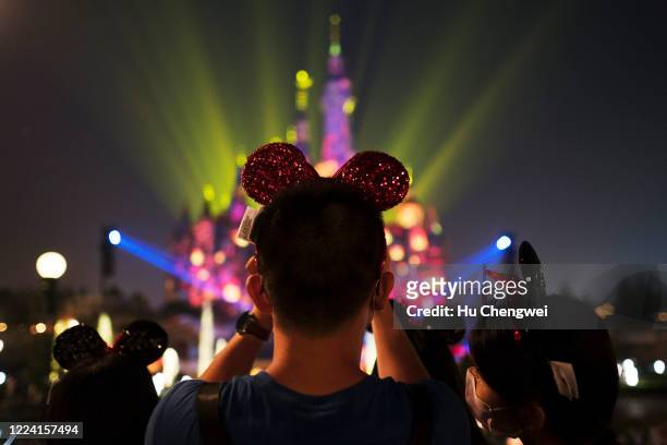 Tourist looks on at Shanghai Disneyland after its reopening on May 11, 2020 in Shanghai, China. Shanghai Disneyland has reopened its gates following...
