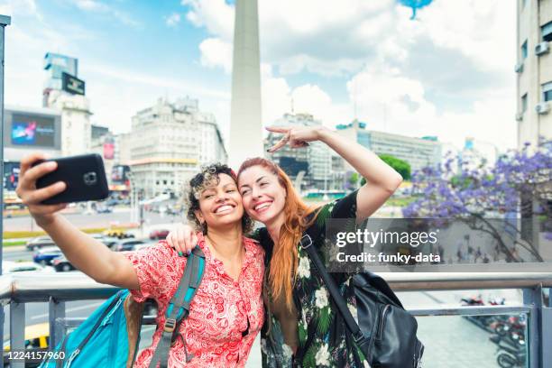 latin american tourist girls in buenos aires - obelisco de buenos aires stock pictures, royalty-free photos & images