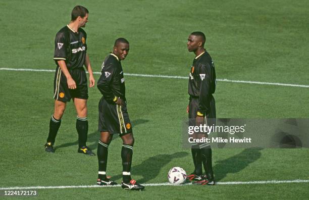 Manchester United strikers Dwight Yorke and Andrew Cole clad in their all black Umbro away kit, prepare to kick off the Premier League game watched...