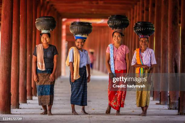 burmese women carrying bowls of rice to the monastery - myanmar food stock pictures, royalty-free photos & images