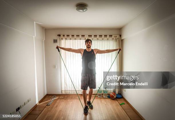 05m tall Argentine basketball player Kevin Hernandez trains in isolation in his 10 square meters living room on May 09, 2020 in Buenos Aires,...