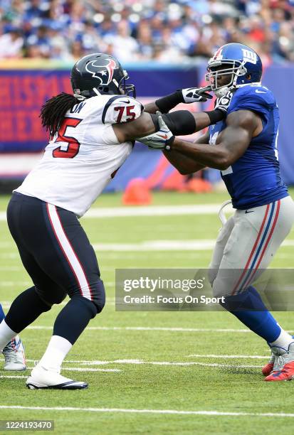 Robert Ayers of the New York Giants fights off the block of Derek Newton of the Houston Texans during an NFL football game September 21, 2014 at...