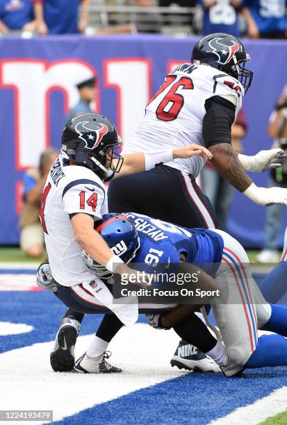 Robert Ayers of the New York Giants puts the pressure on quarterback Ryan Fitzpatrick the Houston Texans during an NFL football game September 21,...