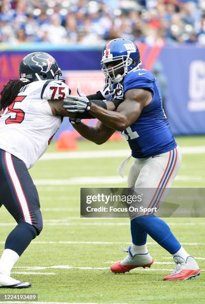 Robert Ayers of the New York Giants fights off the block of Derek Newton of the Houston Texans during an NFL football game September 21, 2014 at...
