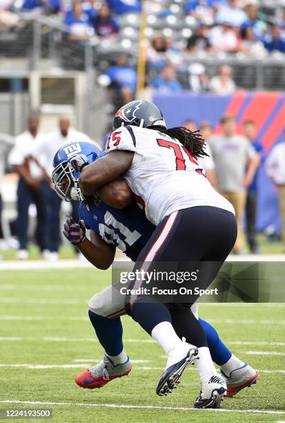 Robert Ayers of the New York Giants fights off the block of Derek Newton of the Houston Texans during an NFL football game September 21, 2014 at...