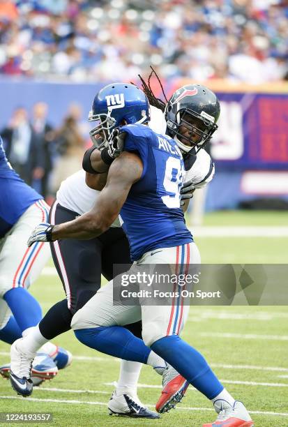 Robert Ayers of the New York Giants fights off the block of Derek Newton of the Houston Texans during an NFL football game September 21, 2014 at...