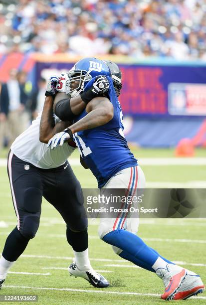 Robert Ayers of the New York Giants fights off the block of Derek Newton of the Houston Texans during an NFL football game September 21, 2014 at...