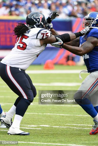 Robert Ayers of the New York Giants fights off the block of Derek Newton of the Houston Texans during an NFL football game September 21, 2014 at...