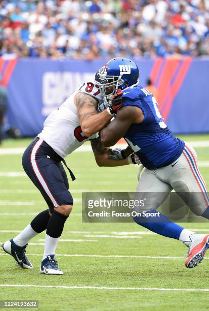 Robert Ayers of the New York Giants fights off the block of C.J. Fiedorowicz of the Houston Texans during an NFL football game September 21, 2014 at...