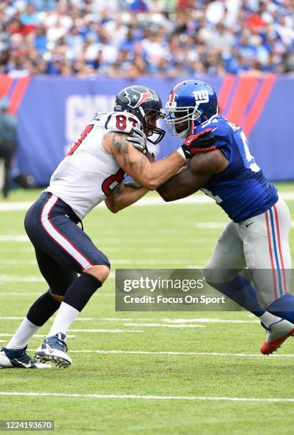 Robert Ayers of the New York Giants fights off the block of C.J. Fiedorowicz of the Houston Texans during an NFL football game September 21, 2014 at...